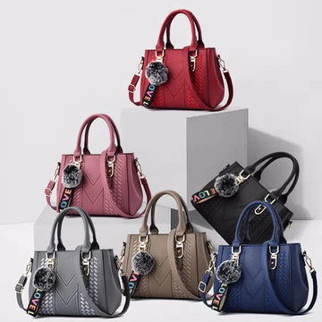 Collection of handbags in various colors with decorative pom-poms on a white background